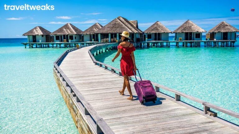 Traveler walking toward overwater villas using map guides ttweakmaps traveltweaks inspiration