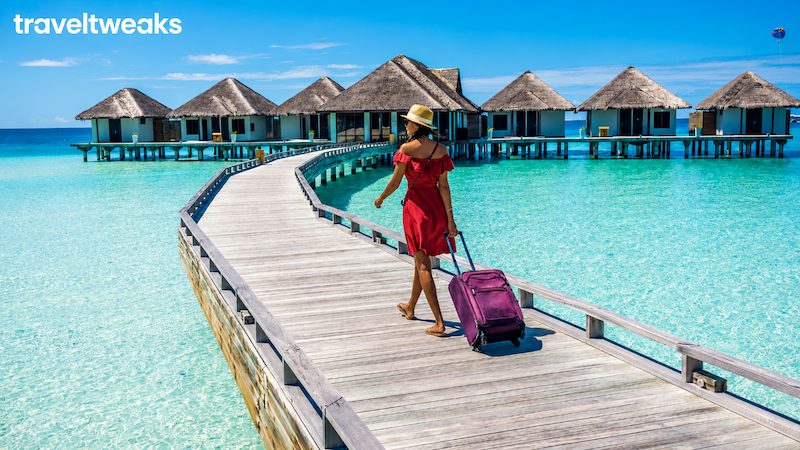 Traveler walking toward overwater villas using map guides ttweakmaps traveltweaks inspiration